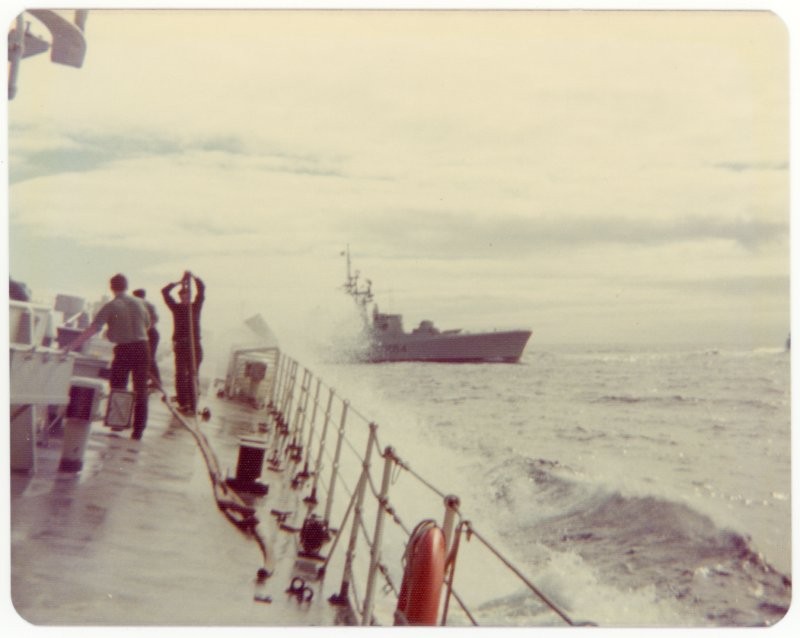 Morning deck evolutions aboard HMCS Mackenzie, HMCS Qu'Appelle off starboard bow, Pacific Ocean, 1975.